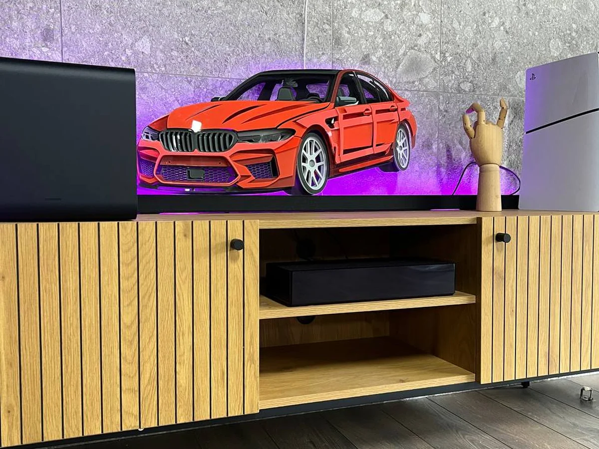 Red StackRise model on a TV console in a living room